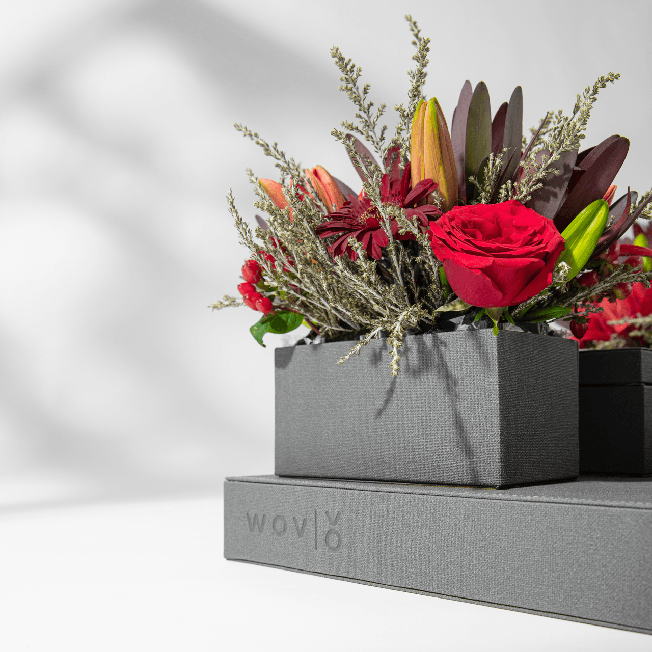 Red roses arranged in a grey Vow linen presentation box