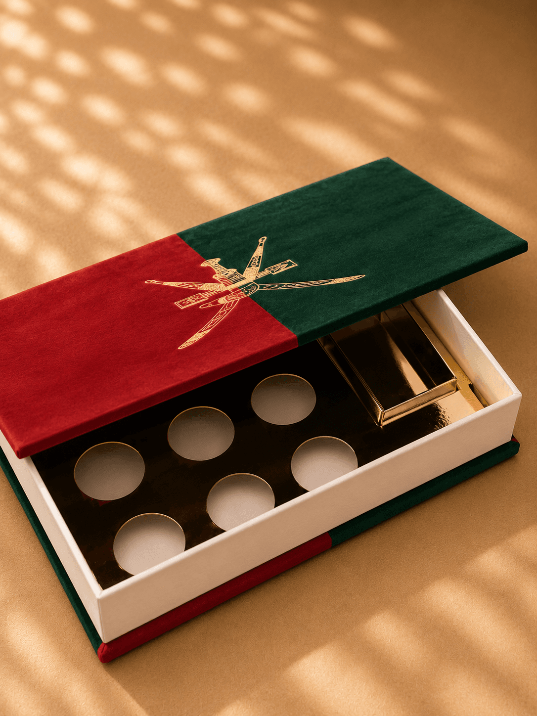 Omani emblem suede book in red and green on warm surface